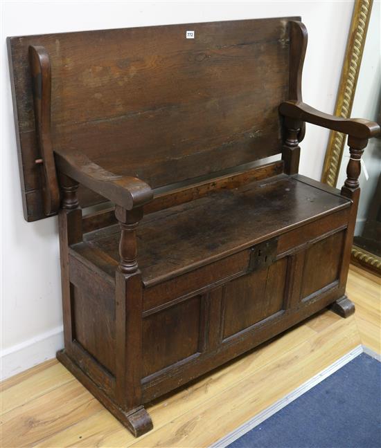 An oak monks bench W.114cm.